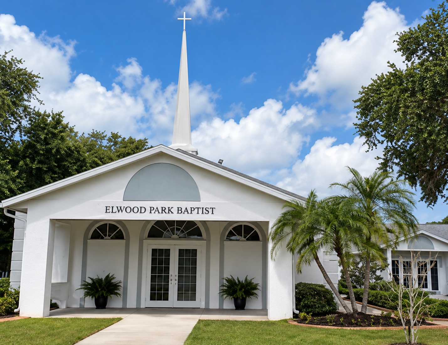 Elwood Park Baptist Church building surrounded by palm trees
